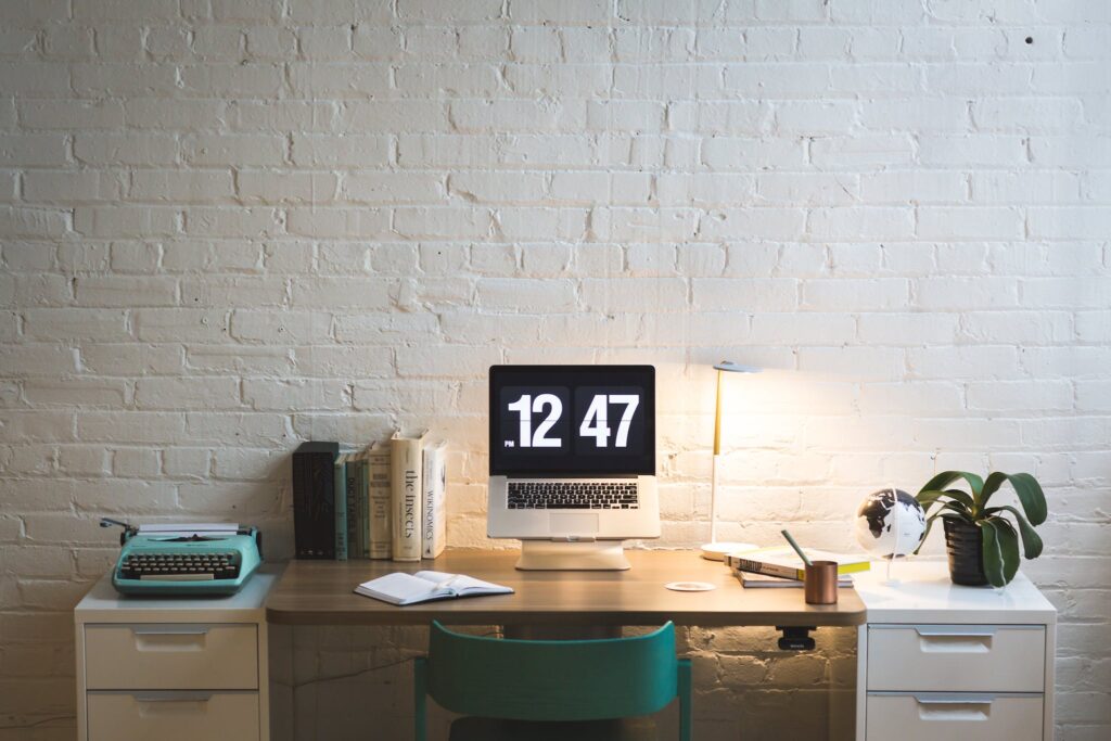 Silver and Black Digital Alarm Clock on Table